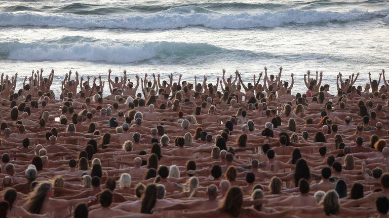 daniel mutinyu add nude people on a beach image